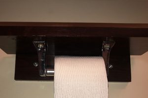 DIY wall mounted shelving with hanging toilet paper dispenser