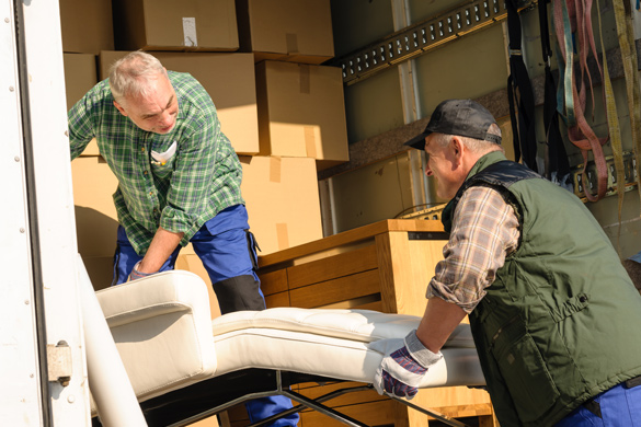 Moving truck being loaded with boxes and furniture