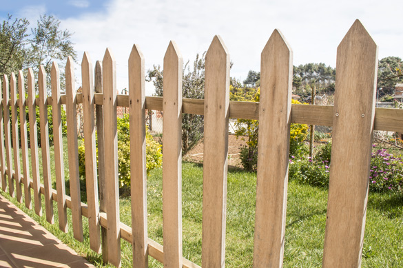 Wooden fence enclosing yard and home exterior